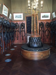 Huge stables filled with carriages and harnesses